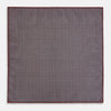 View 6 of product The Turnbull & Asser UK Geometric Burgundy Tile Pocket Square in Silk is displayed partly folded, showcasing its bold geometric grid pattern with concentric burgundy squares on the front and a contrasting black-and-white dotted design on the reverse.