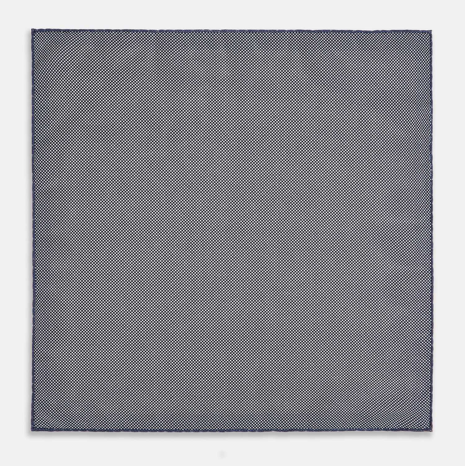 View 6 of product The Geometric Blue Pocket Square in Silk from Turnbull & Asser UK showcases a blue border and double-sided design, with a geometric pattern at the center. A folded corner reveals a refined, tighter dot motif on the reverse side, emphasizing the intricate craftsmanship of this finely woven accessory.