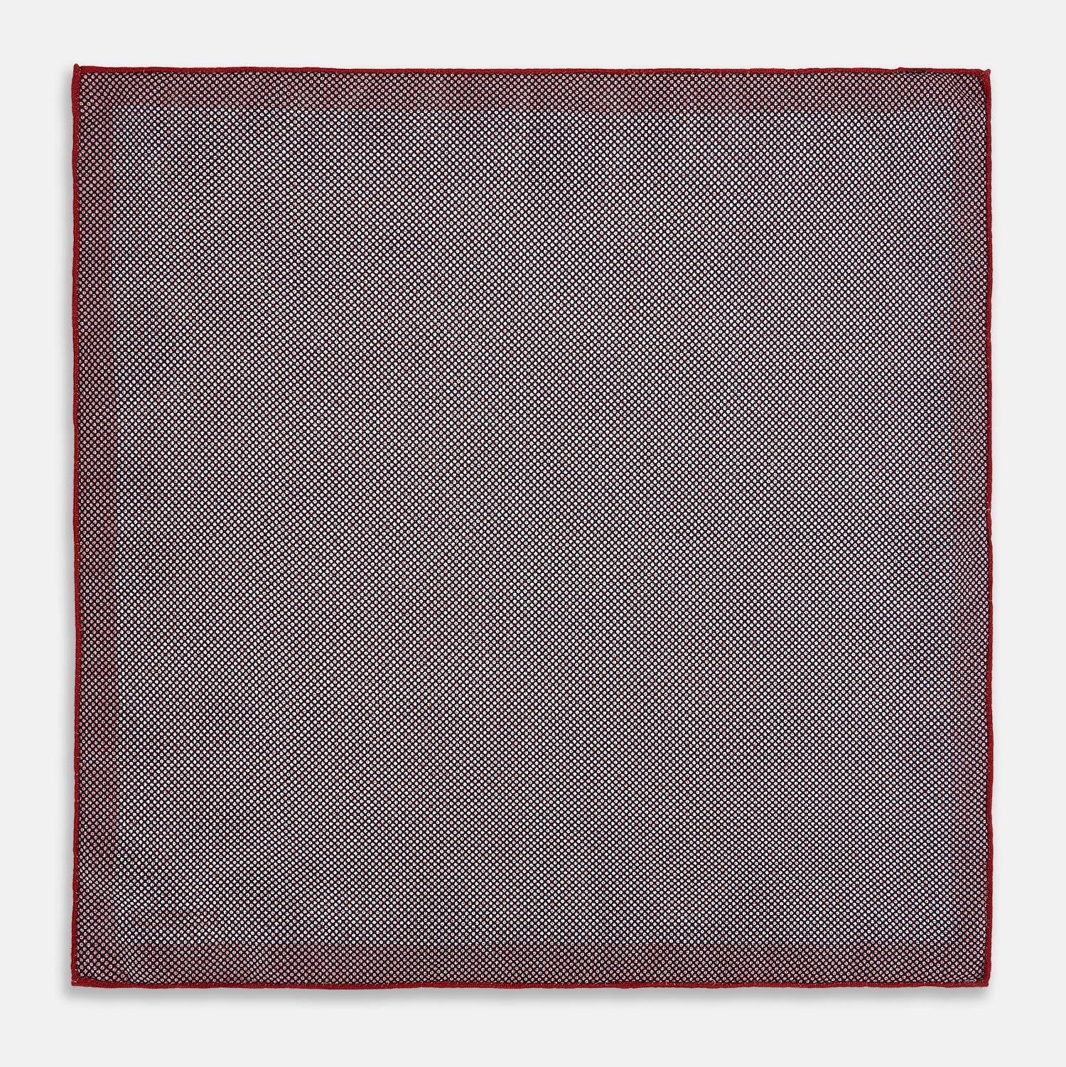 View 6 of product Turnbull & Asser UK’s Geometric Red Pocket Square in Silk features a small white checkered pattern and a cleverly flipped corner to showcase its contrasting black and white micro-dot reverse design.