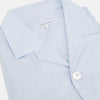 View 2 of product The Turnbull & Asser Pale Blue Fine Micro Check Pyjama Shirt features long sleeves, a notched collar, and a chest pocket—styled flat on white, ideal for elegant nightwear.