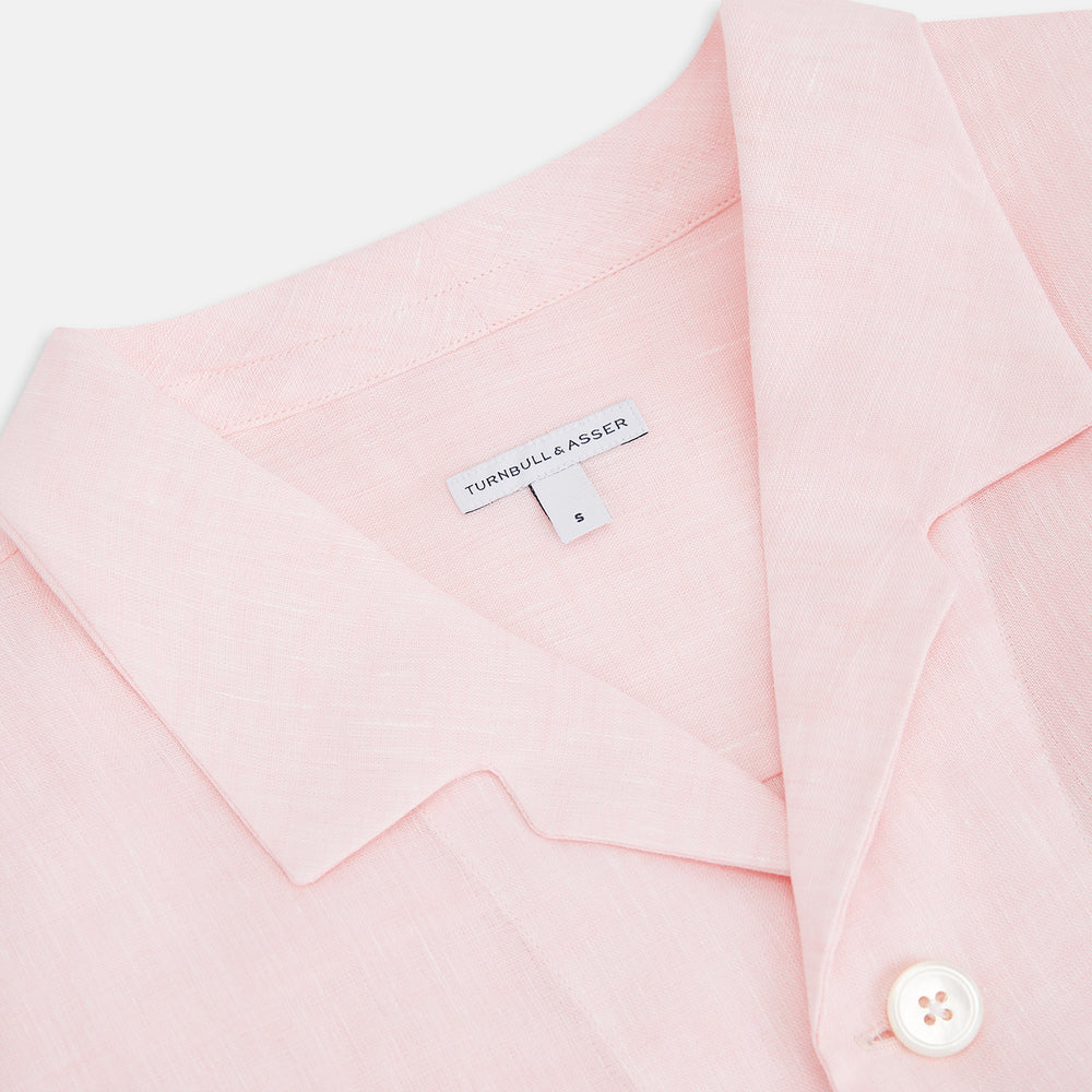 The Turnbull & Asser Pale Pink Linen Pyjama Shirt features long sleeves, a chest pocket, and a classic button-up design—ideal for stylish nightwear or relaxed homewear. Shown laid flat on a white background.