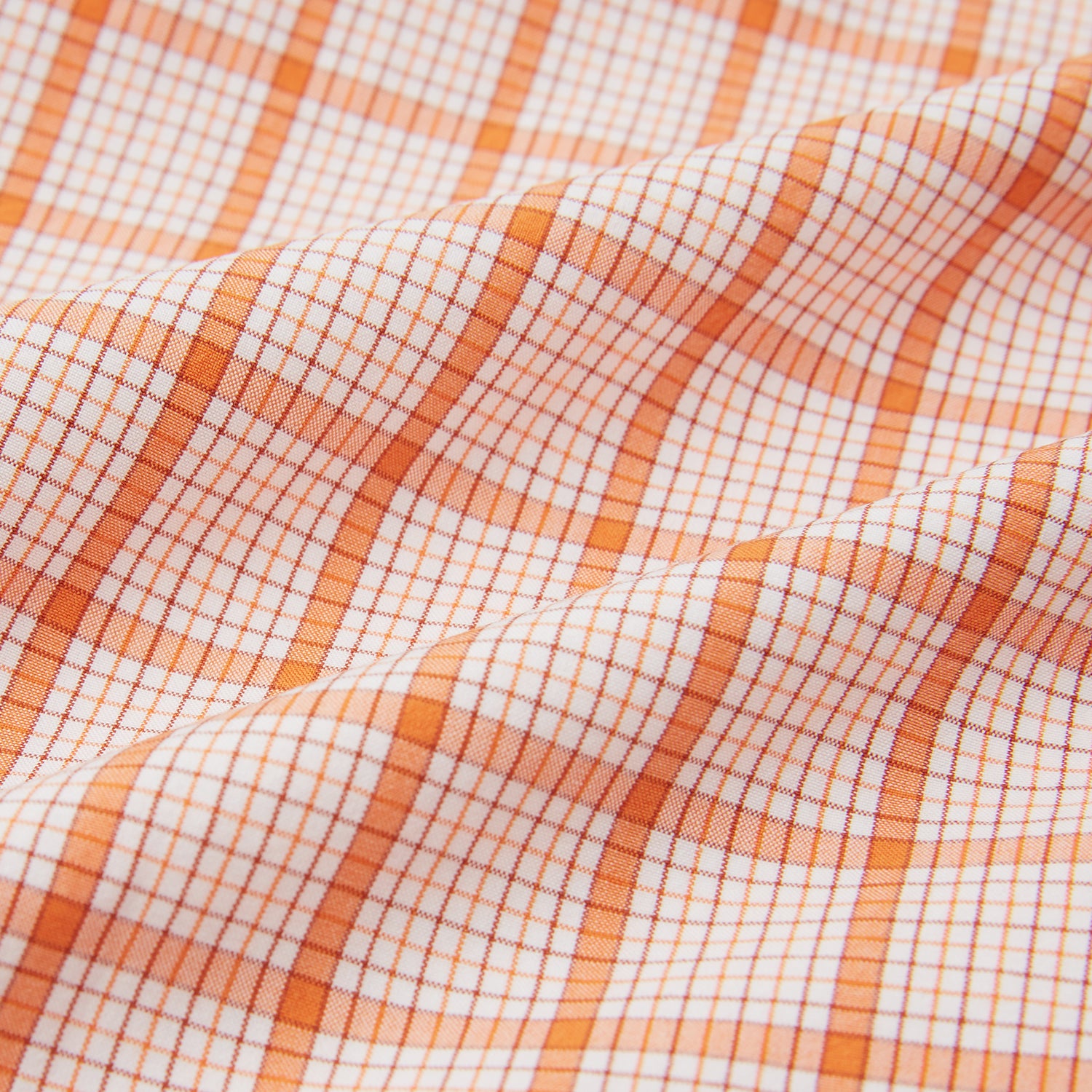 View 6 of product The Orange Graph Overlay Check Pyjama Shirt by Turnbull & Asser features long sleeves, a notched collar, and a front chest pocket, shown here laid flat on a white background.
