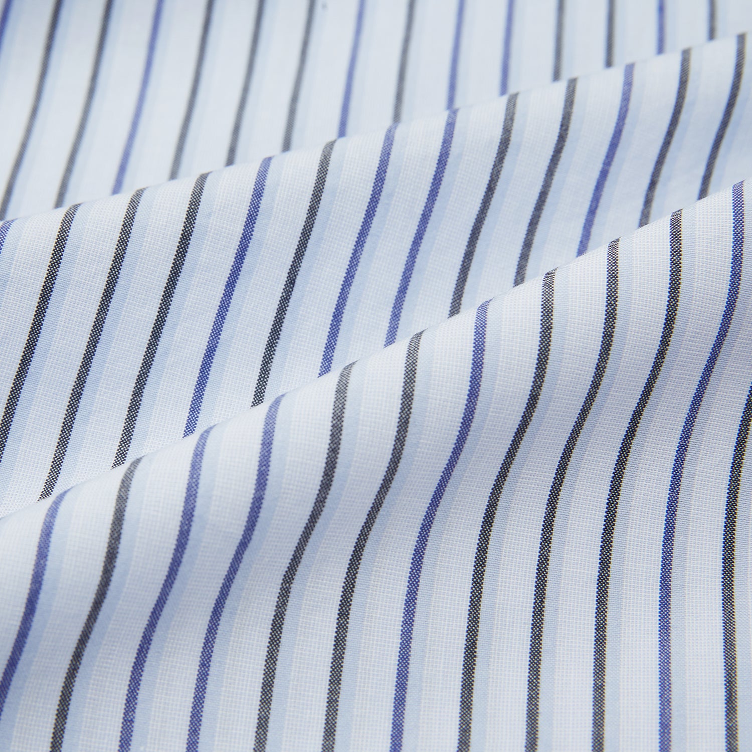 View 6 of product The Turnbull & Asser Blue Shadow Pinstripe Pyjama Shirt features blue and white vertical stripes, a chest pocket, and long sleeves—ideal for elegant homewear, shown against a white background.