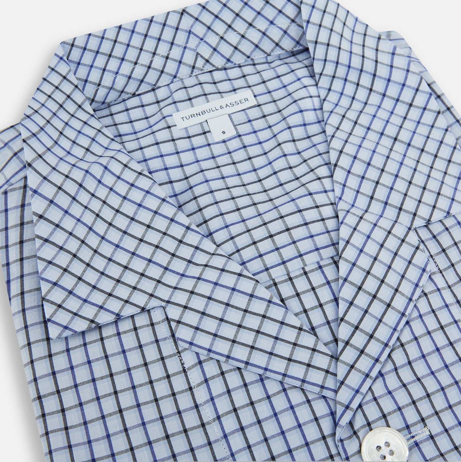 View 2 of product The Turnbull & Asser Blue Shadow Check Pyjama Shirt features long sleeves, a button-up front, collar, and chest pocket—ideal for refined loungewear or stylish nightwear.