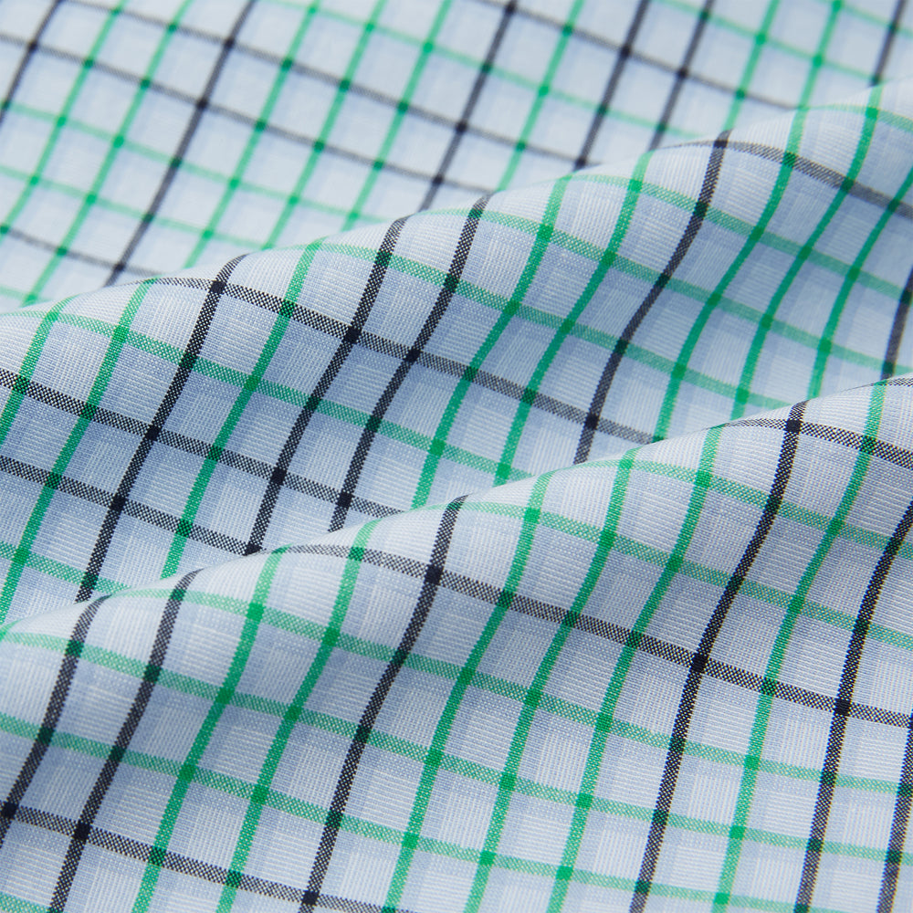 The Turnbull & Asser Green and Blue Shadow Check Pyjama Shirt, with a collar and chest pocket, is perfect loungewear or nightwear; shown laid flat on a white background.
