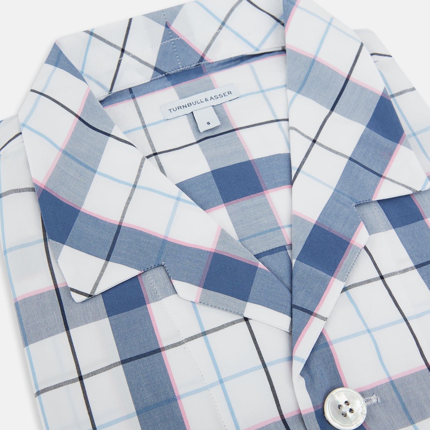View 2 of product The Turnbull & Asser Blue Blazer Check Pyjama Shirt features long sleeves, a classic collar, and white buttons in a blue and white plaid, offering elegant loungewear style.