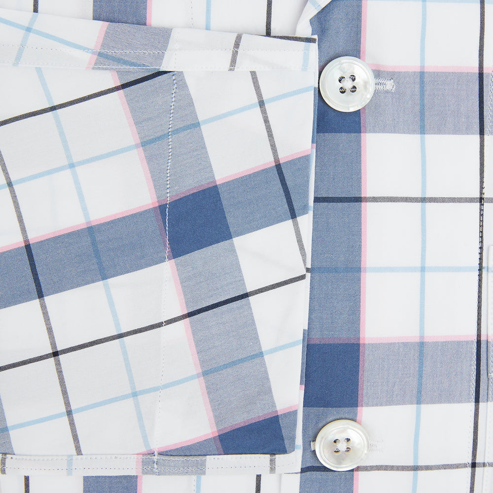 The Turnbull & Asser Blue Blazer Check Pyjama Shirt features long sleeves, a classic collar, and white buttons in a blue and white plaid, offering elegant loungewear style.