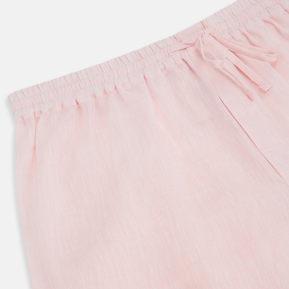 The Turnbull & Asser Pale Pink Linen Pyjama Trousers feature an elastic waistband and drawstring, combining comfort and style. Displayed flat on a plain white background, these trousers are perfect sleepwear.