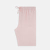 View 4 of product The Turnbull & Asser Pale Pink Linen Pyjama Trousers feature an elastic waistband and drawstring, combining comfort and style. Displayed flat on a plain white background, these trousers are perfect sleepwear.