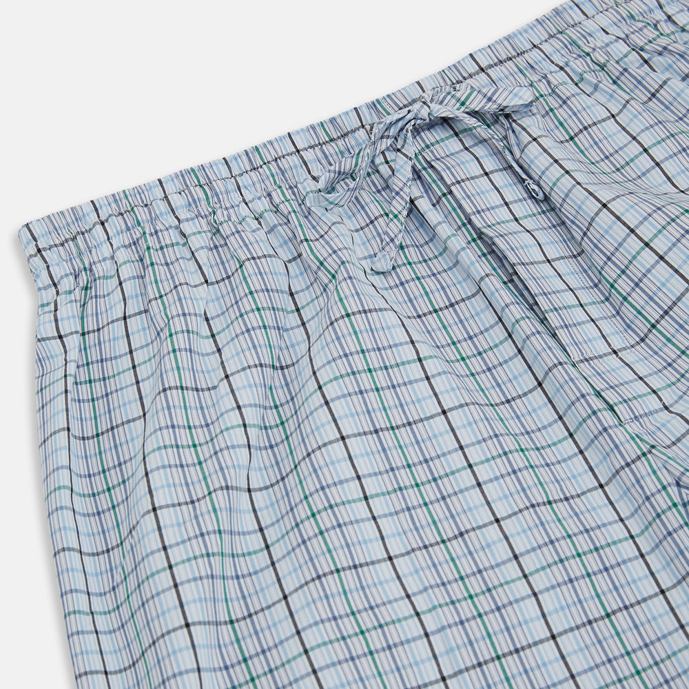 Turnbull & Asser’s Blue and Green Multi Track Check Pyjama Trousers feature an elastic waistband with drawstring and a blue-green check pattern on a white background, shown laid flat on a white surface.