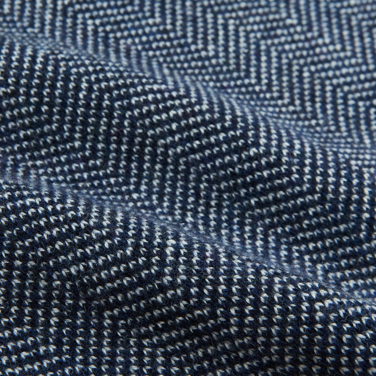 View 3 of product The Turnbull & Asser Reversible Navy and White Herringbone Cashmere Scarf is a timeless winter accessory, featuring an elegant two-tone pattern and luxurious softness.