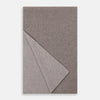 View 2 of product The Turnbull & Asser Reversible Grey Herringbone Cashmere Scarf is artfully folded and displayed on a plain white background.