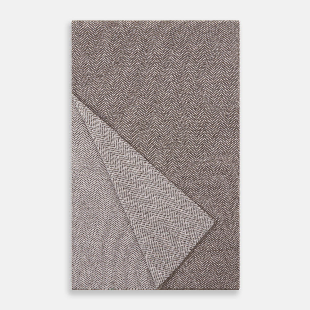 The Turnbull & Asser Reversible Grey Herringbone Cashmere Scarf is artfully folded and displayed on a plain white background.