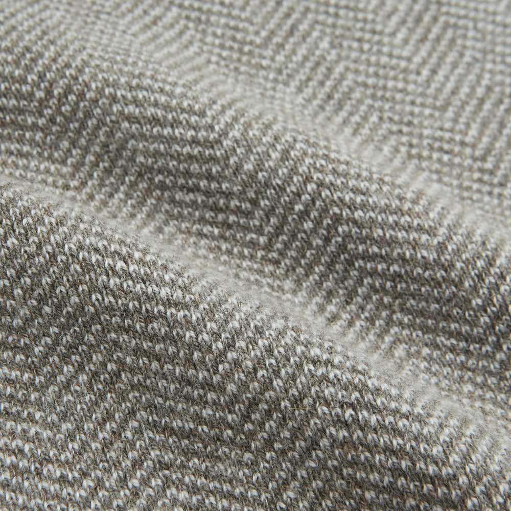 The Turnbull & Asser Reversible Grey Herringbone Cashmere Scarf is artfully folded and displayed on a plain white background.