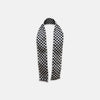 View 1 of product The Chequered Navy on White Frame Small Scarf in Silk by Turnbull & Asser UK is a long silk accessory featuring a classic black and white checkerboard pattern laid flat against a white background. Its ends are finished with a thin, fringed border, while the top edge is accented by diagonal stripes. The double-sided chequered design adds a stylish twist, with touches of navy and subtle hints of white bringing sophisticated detail to this timeless look.