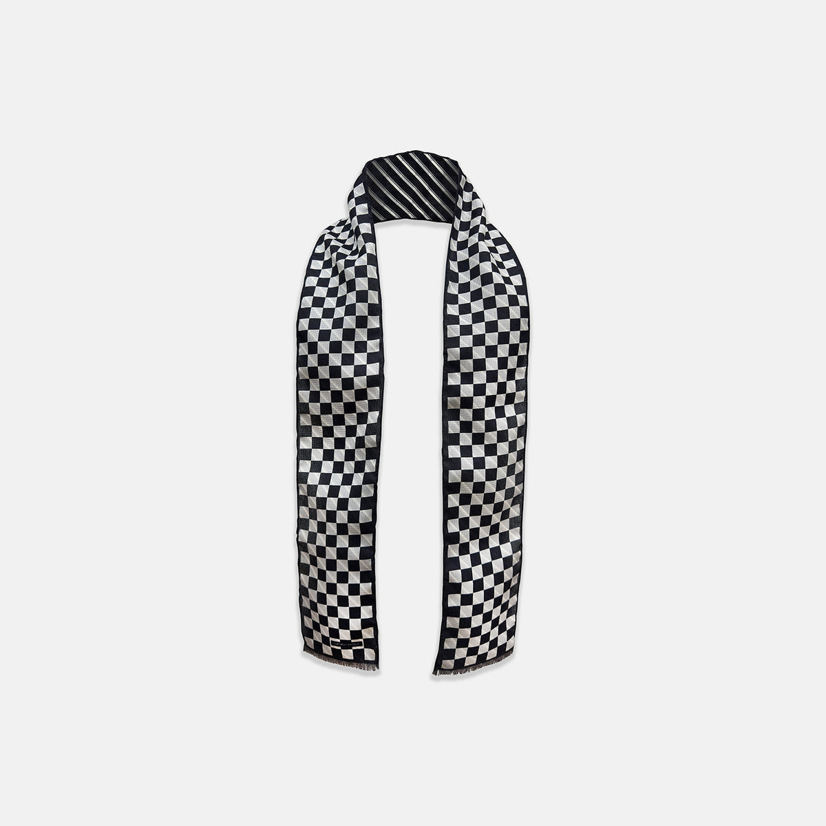View 1 of product The Chequered Navy on Navy Frame Small Scarf in Silk from Turnbull & Asser UK, showcasing a sophisticated navy checkerboard pattern, is displayed against a plain white background.