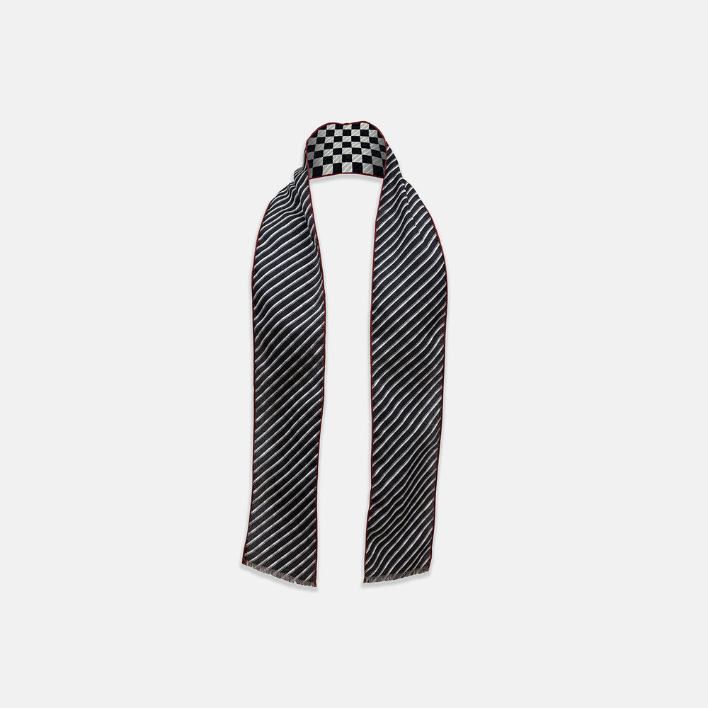 Introducing the Chequered Navy on Red Frame Small Scarf in Silk by Turnbull & Asser UK—a luxurious silk accessory featuring a navy and white chequered pattern, accented with thin red borders and delicate fringe at each end. Displayed against a white background, this scarf pays homage to British motoring heritage and the enduring elegance of Concours style.