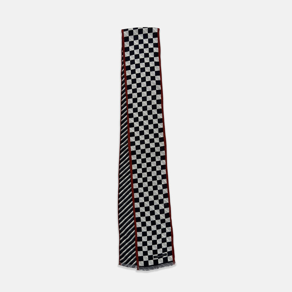 Introducing the Chequered Navy on Red Frame Small Scarf in Silk by Turnbull & Asser UK—a luxurious silk accessory featuring a navy and white chequered pattern, accented with thin red borders and delicate fringe at each end. Displayed against a white background, this scarf pays homage to British motoring heritage and the enduring elegance of Concours style.