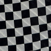 View 4 of product Introducing the Chequered Navy on Red Frame Small Scarf in Silk by Turnbull & Asser UK—a luxurious silk accessory featuring a navy and white chequered pattern, accented with thin red borders and delicate fringe at each end. Displayed against a white background, this scarf pays homage to British motoring heritage and the enduring elegance of Concours style.