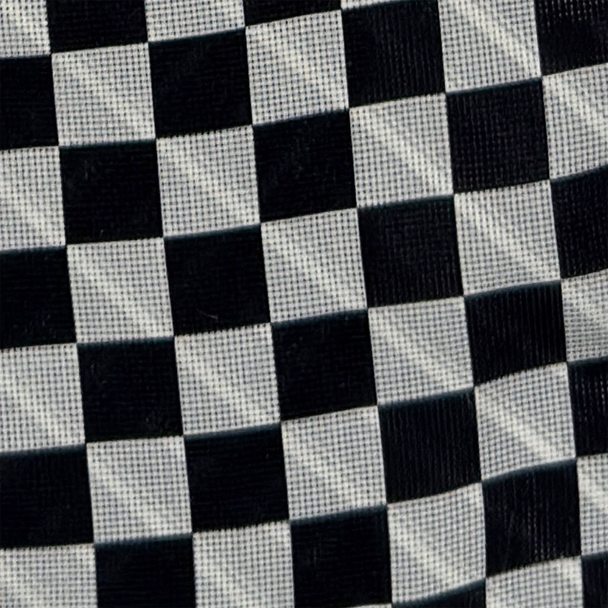 View 4 of product Introducing the Chequered Navy on Red Frame Small Scarf in Silk by Turnbull & Asser UK—a luxurious silk accessory featuring a navy and white chequered pattern, accented with thin red borders and delicate fringe at each end. Displayed against a white background, this scarf pays homage to British motoring heritage and the enduring elegance of Concours style.