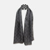 View 2 of product A Chequered Navy on White Frame Large Scarf in Silk from Turnbull & Asser UK, featuring a striking navy and white checkerboard motif inspired by classic British motoring heritage, is gracefully displayed over an invisible stand with its ends cascading downward and the top artfully folded into a striped semicircle—an impeccable choice for making a stylish statement at the Concours of Elegance 2026.