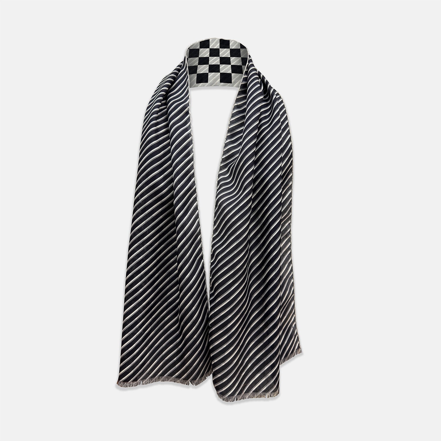 View 2 of product A Chequered Navy on White Frame Large Scarf in Silk from Turnbull & Asser UK, featuring a striking navy and white checkerboard motif inspired by classic British motoring heritage, is gracefully displayed over an invisible stand with its ends cascading downward and the top artfully folded into a striped semicircle—an impeccable choice for making a stylish statement at the Concours of Elegance 2026.