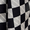 View 4 of product A Chequered Navy on White Frame Large Scarf in Silk from Turnbull & Asser UK, featuring a striking navy and white checkerboard motif inspired by classic British motoring heritage, is gracefully displayed over an invisible stand with its ends cascading downward and the top artfully folded into a striped semicircle—an impeccable choice for making a stylish statement at the Concours of Elegance 2026.