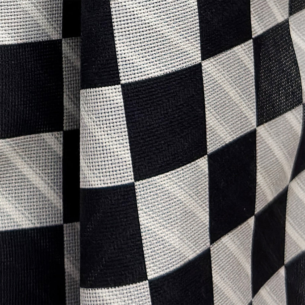 A Chequered Navy on White Frame Large Scarf in Silk from Turnbull & Asser UK, featuring a striking navy and white checkerboard motif inspired by classic British motoring heritage, is gracefully displayed over an invisible stand with its ends cascading downward and the top artfully folded into a striped semicircle—an impeccable choice for making a stylish statement at the Concours of Elegance 2026.