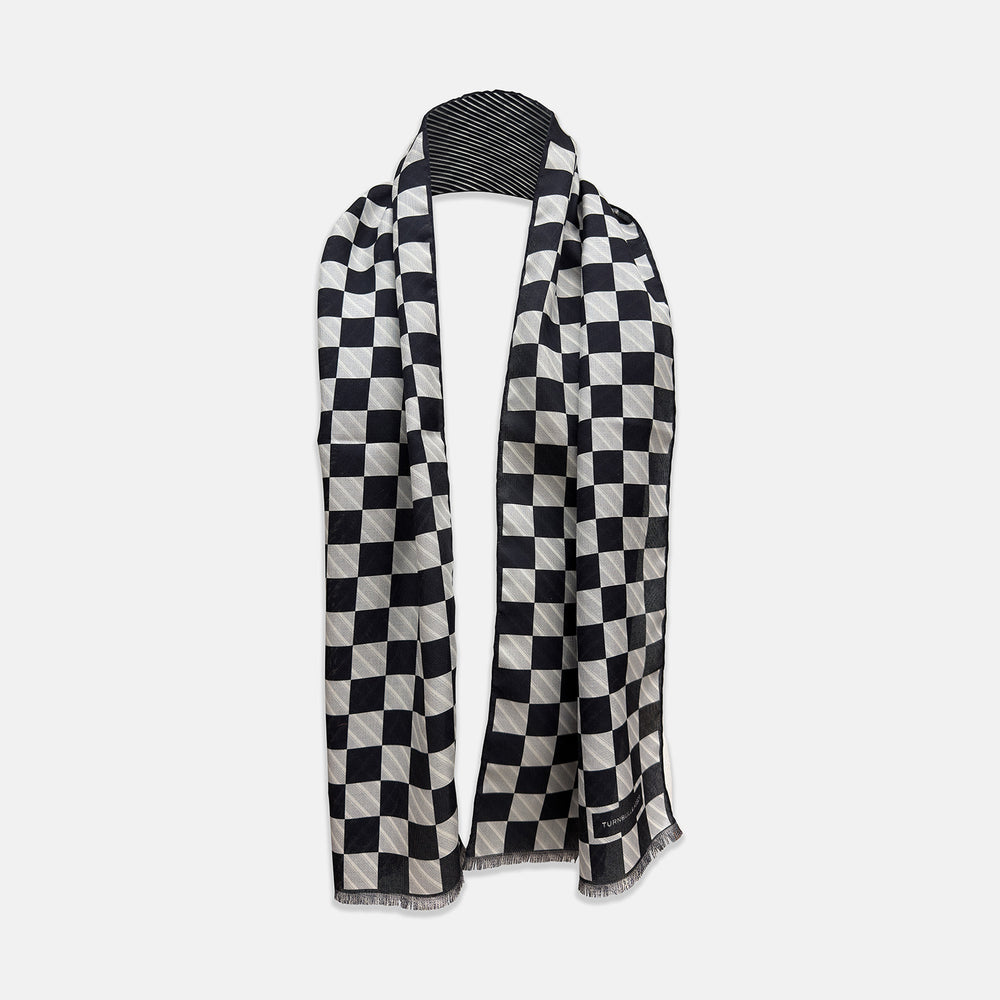 A Chequered Navy on Navy Frame Large Scarf in Silk by Turnbull & Asser UK, featuring a navy checkered design with striped detailing at the neck, is elegantly displayed against a plain white background—an accessory inspired by the enduring sophistication of British motoring, perfect for occasions such as the Concours of Elegance 2026.
