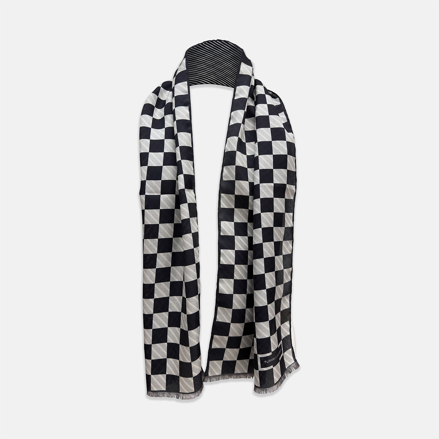 View 1 of product A Chequered Navy on Navy Frame Large Scarf in Silk by Turnbull & Asser UK, featuring a navy checkered design with striped detailing at the neck, is elegantly displayed against a plain white background—an accessory inspired by the enduring sophistication of British motoring, perfect for occasions such as the Concours of Elegance 2026.