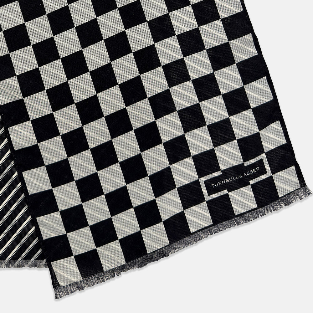 A Chequered Navy on Navy Frame Large Scarf in Silk by Turnbull & Asser UK, featuring a navy checkered design with striped detailing at the neck, is elegantly displayed against a plain white background—an accessory inspired by the enduring sophistication of British motoring, perfect for occasions such as the Concours of Elegance 2026.