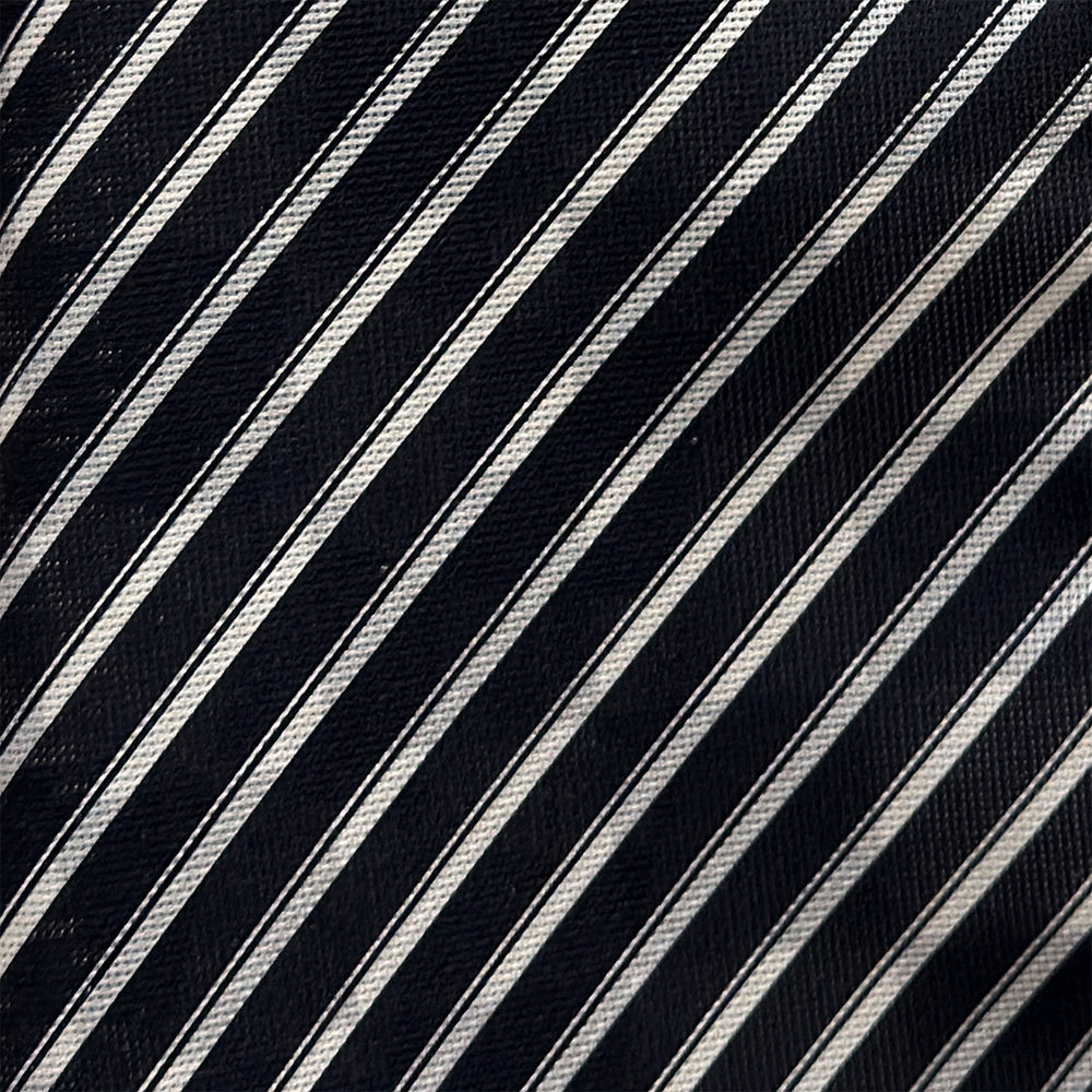 A Chequered Navy on Navy Frame Large Scarf in Silk by Turnbull & Asser UK, featuring a navy checkered design with striped detailing at the neck, is elegantly displayed against a plain white background—an accessory inspired by the enduring sophistication of British motoring, perfect for occasions such as the Concours of Elegance 2026.