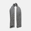 View 2 of product A Chequered Navy & White Scarf in Silk by Turnbull & Asser UK is displayed against a plain white background, showcasing its long, luxurious silk fabric with a striking navy and white checkered pattern.