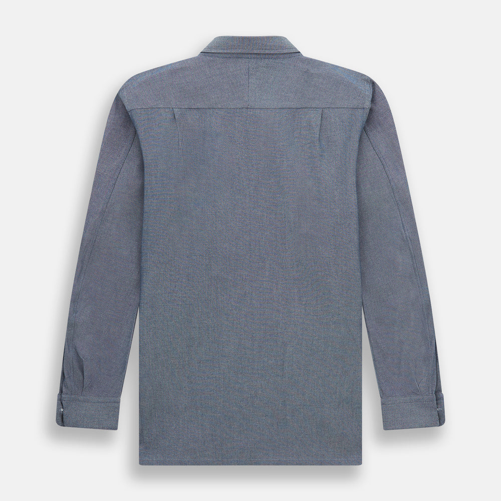 The Turnbull & Asser Steel Blue Piccadilly Shirt features long sleeves, a button-up front, two chest pockets, and white buttons, shown against a plain white background.