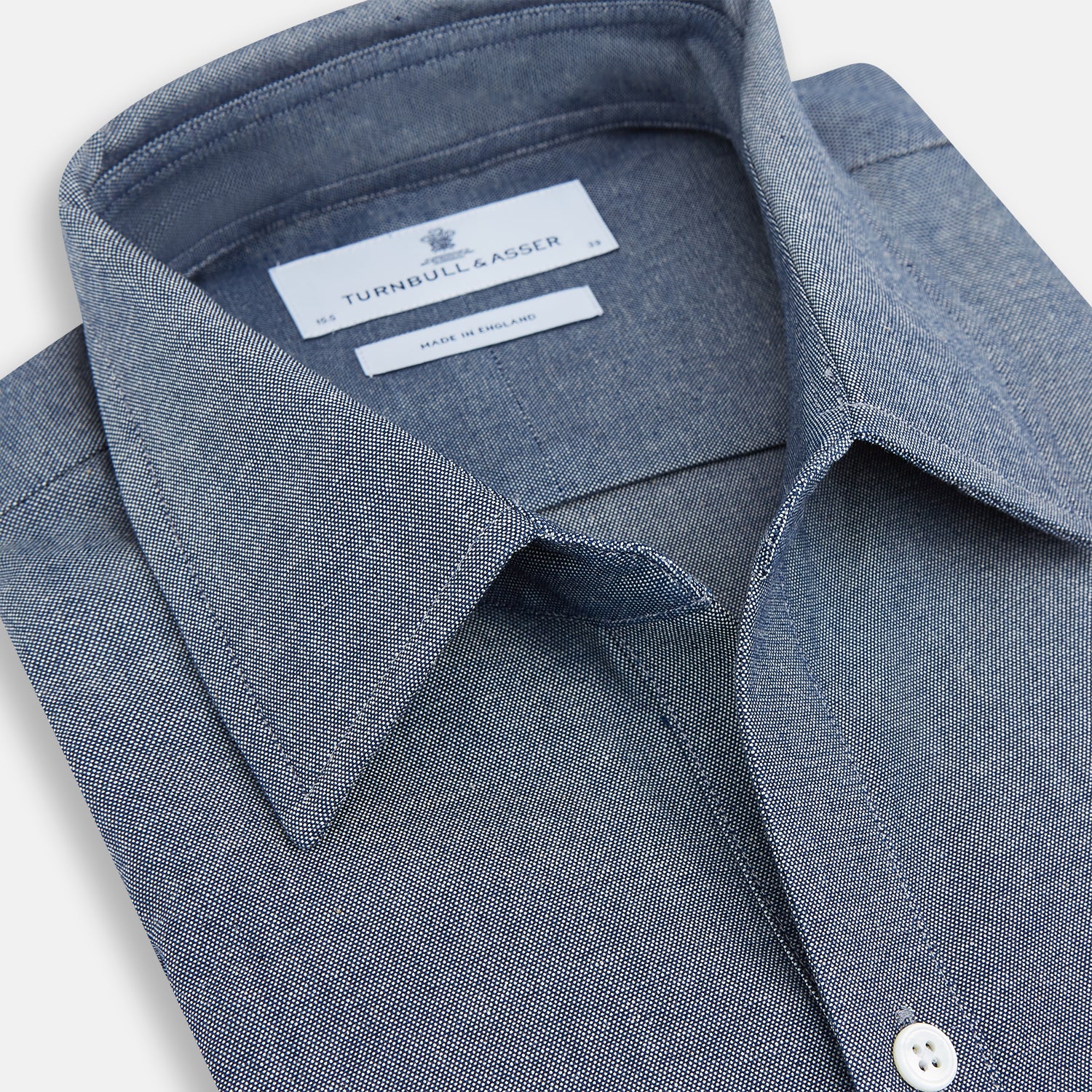 View 2 of product The Turnbull & Asser Steel Blue Piccadilly Shirt features long sleeves, a button-up front, two chest pockets, and white buttons, shown against a plain white background.