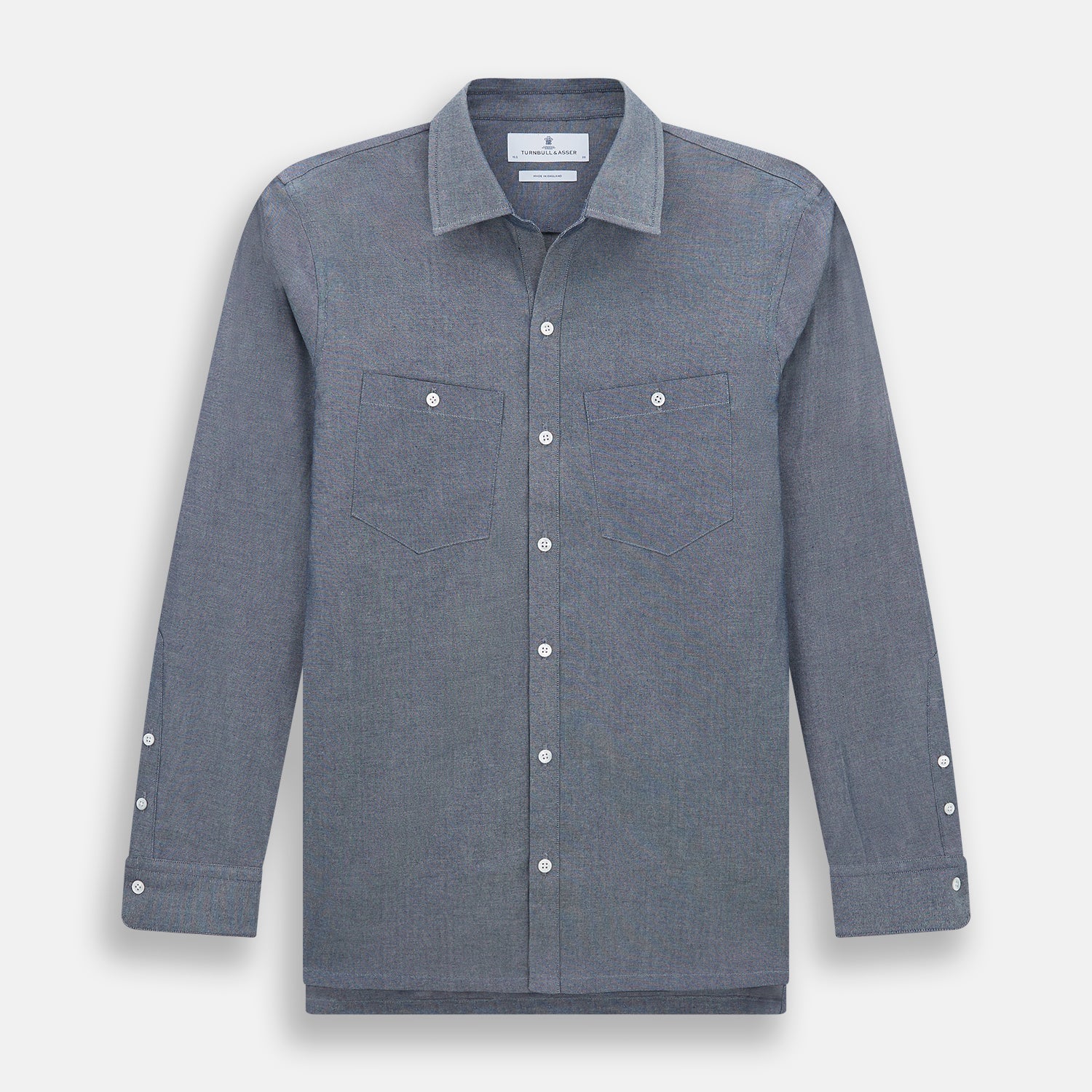 View 1 of product The Turnbull & Asser Steel Blue Piccadilly Shirt features long sleeves, a button-up front, two chest pockets, and white buttons, shown against a plain white background.