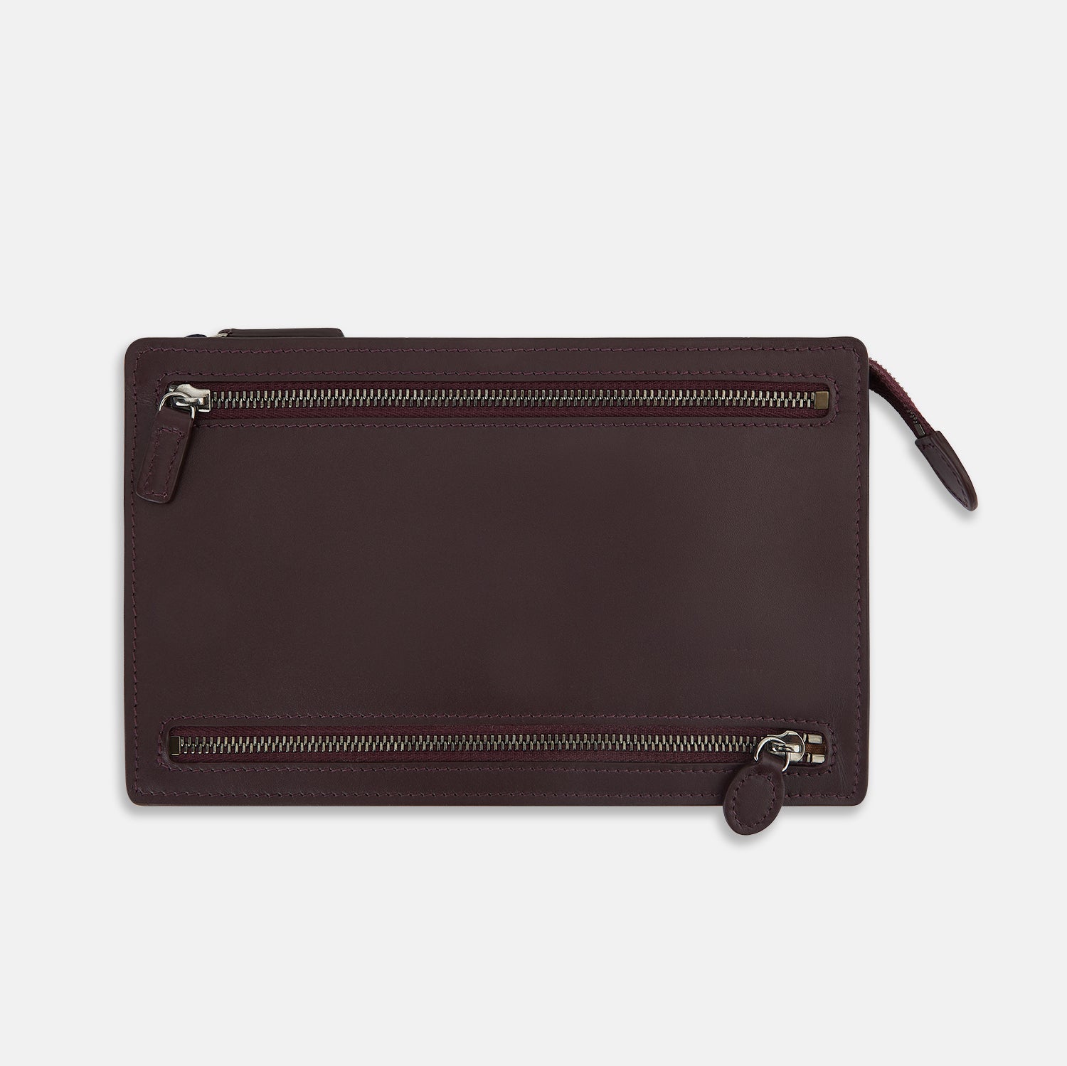 View 1 of product The Turnbull & Asser UK Burgundy Leather Zip Envelope Pouch features two horizontal zipper compartments with matching leather pulls, making it a stylish travel accessory or passport holder.