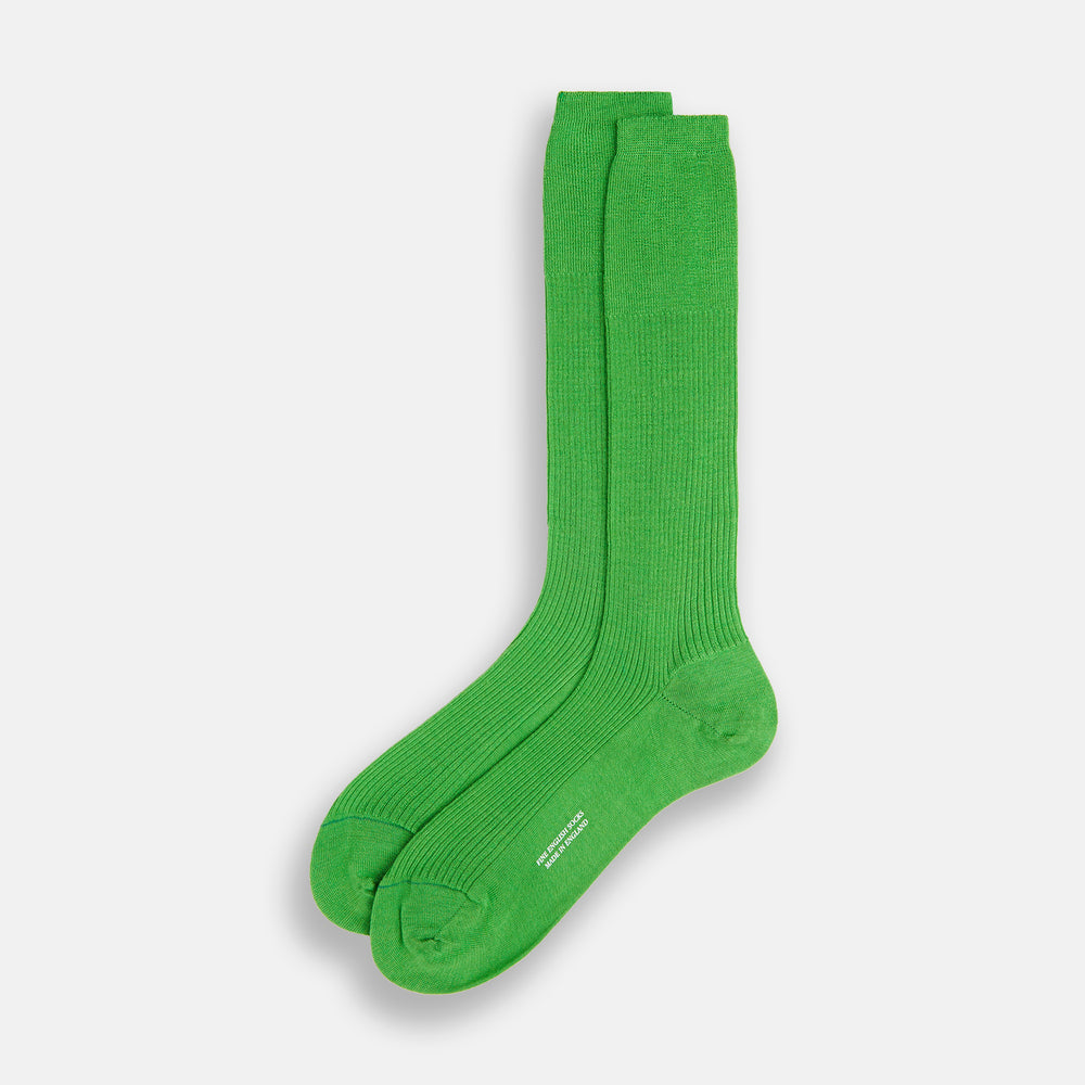 A single Bright Green Mid-Length Merino Sock by Turnbull & Asser is displayed standing with the heel slightly lifted against a plain white background.