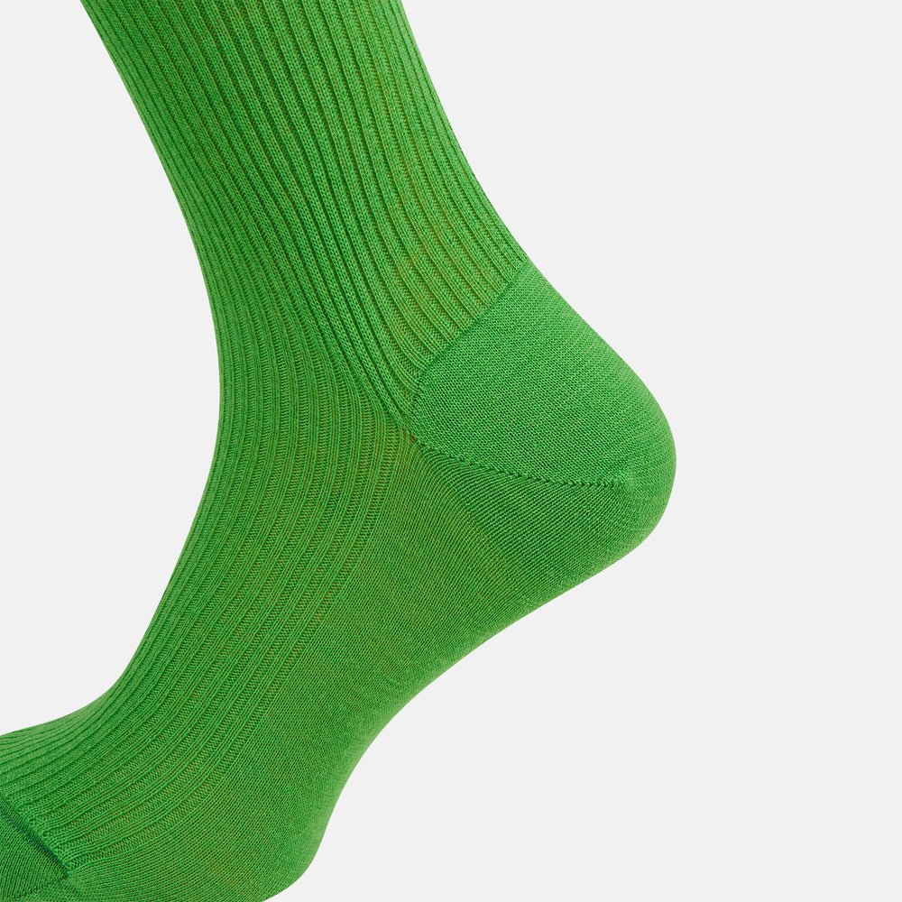 A single Bright Green Mid-Length Merino Sock by Turnbull & Asser is displayed standing with the heel slightly lifted against a plain white background.