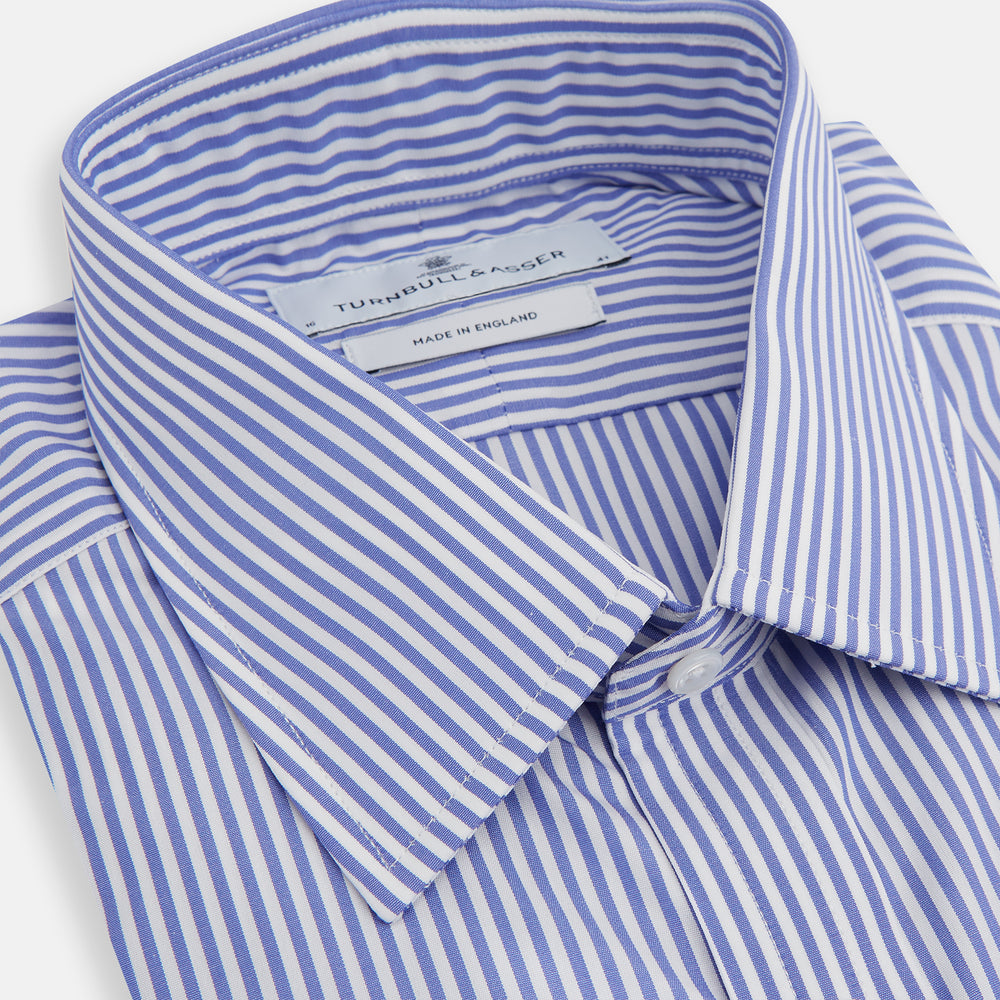 The Turnbull & Asser Blue Bengal Stripe Shirt features a T&A collar, 3-button cuffs, and classic blue and white vertical stripes, shown neatly laid flat against a white background.