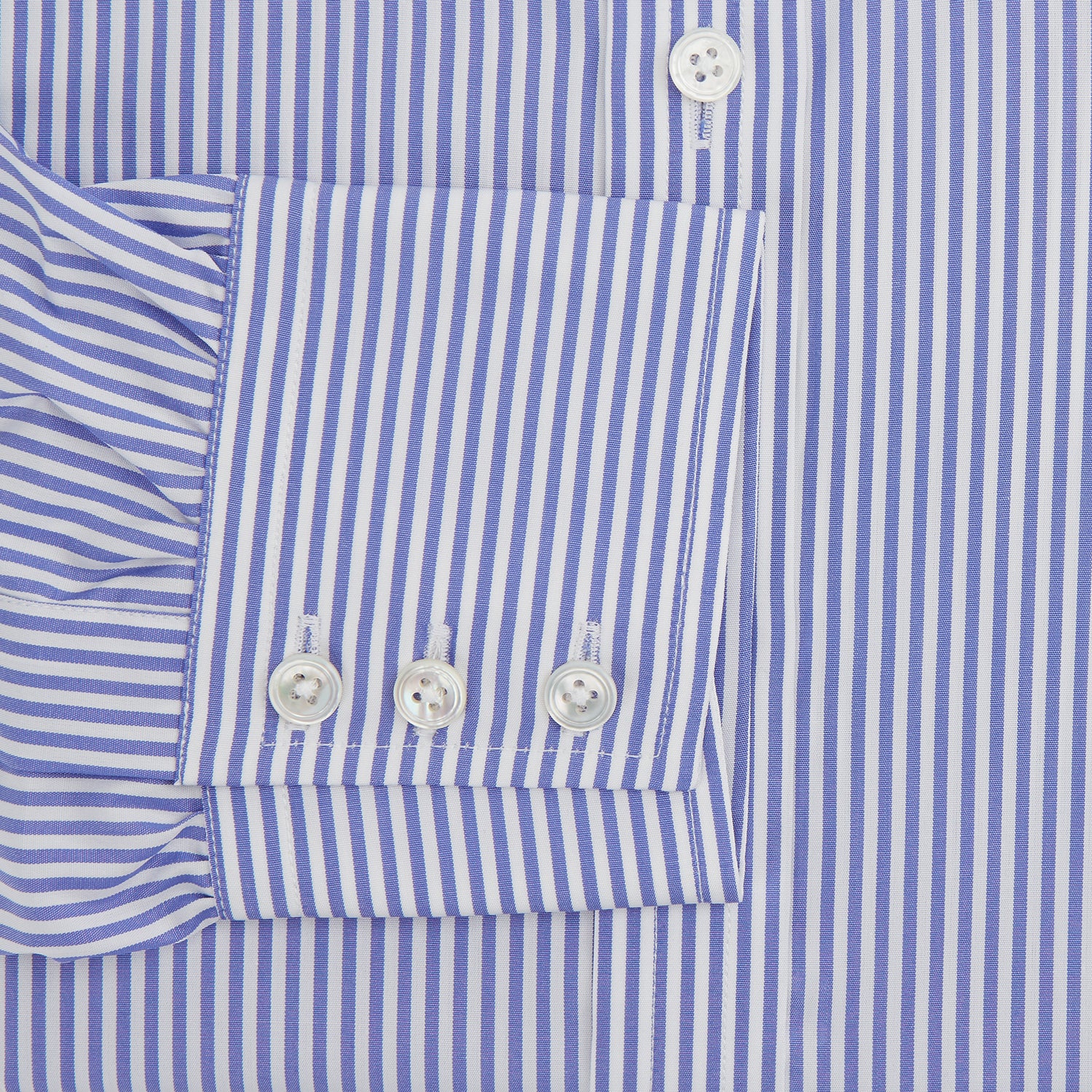 View 3 of product The Turnbull & Asser Blue Bengal Stripe Shirt features a T&A collar, 3-button cuffs, and classic blue and white vertical stripes, shown neatly laid flat against a white background.