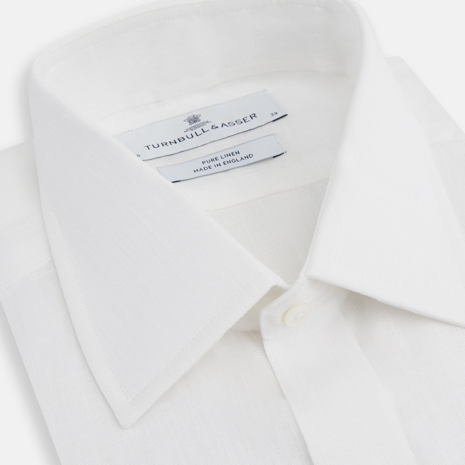 View 2 of product The Turnbull & Asser White Linen Shirt features a T&A collar and 3-button cuffs—an essential summer staple, shown here laid flat on a white background.