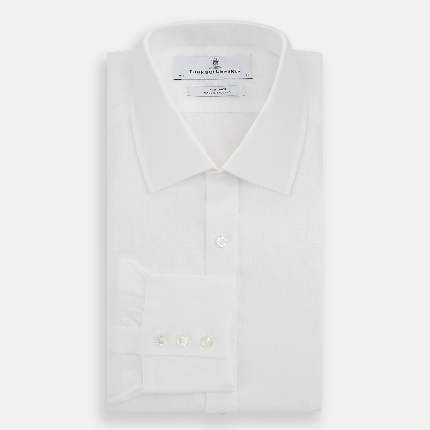 View 4 of product The Turnbull & Asser White Linen Shirt features a T&A collar and 3-button cuffs—an essential summer staple, shown here laid flat on a white background.