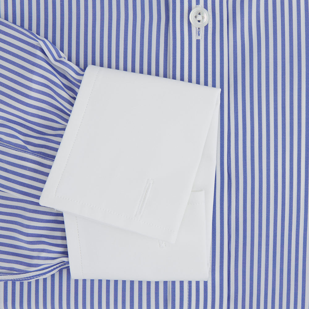 The Gekko Shirt with Contrast T&A Collar and Double Cuffs by Turnbull & Asser features blue and white vertical stripes, a white collar, and double cuffs, inspired by the Wall Street film. Displayed on a plain white background.
