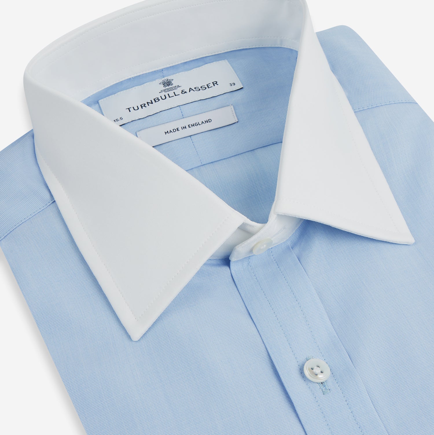 View 2 of product Turnbull & Asser Light Blue End-on-End Shirt features a contrast T&A white collar, double cuffs, long sleeves, and button-down front. Displayed on a plain white background.