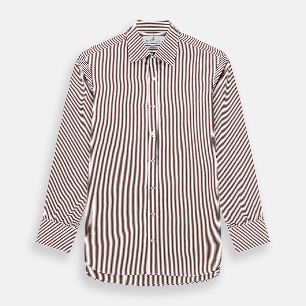 The Turnbull & Asser Burgundy Halo Stripe Winston Shirt features long sleeves, a classic T&A collar, buttoned cuffs, narrow vertical burgundy and white stripes, and is crafted from organic cotton. Displayed on a white background.