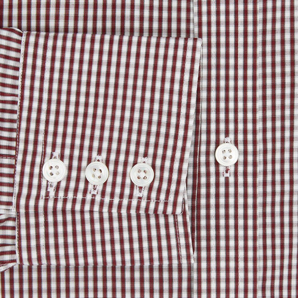 The Turnbull & Asser Burgundy Micro Check Winston Shirt is a long-sleeved, button-up Mayfair fit dress shirt with a collar and buttoned cuffs, featuring a small red and white check pattern and shown on a white background.