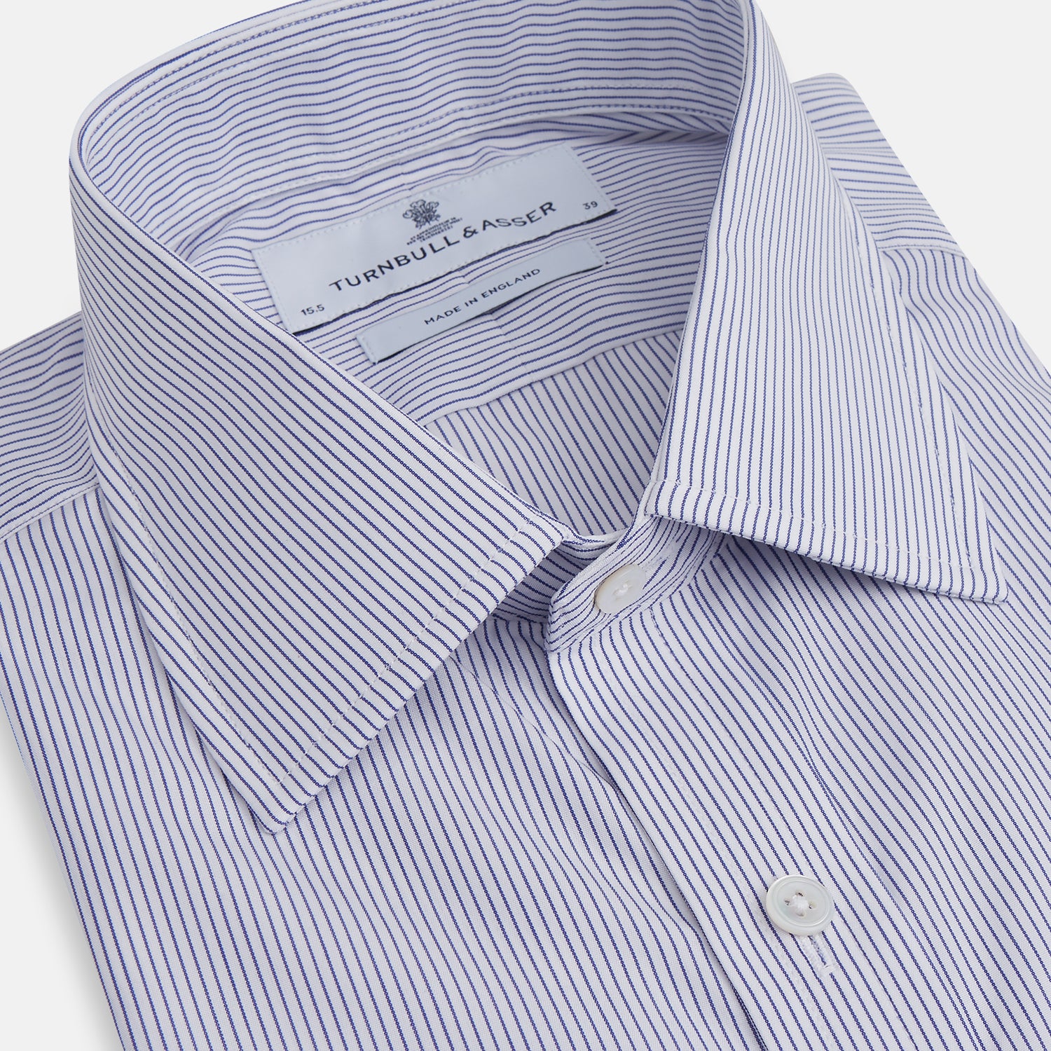 View 2 of product The Turnbull & Asser Blue Pinstripe Mayfair Shirt is a cotton poplin, long-sleeve button-down with a classic collar and white buttons, shown laid flat on a white background.