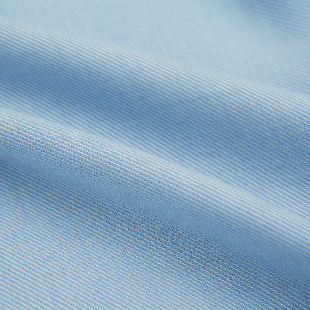 The Turnbull & Asser Blue Cotton Cashmere Mayfair Shirt features long sleeves, a classic collar, buttoned cuffs, and white buttons, shown against a white background.