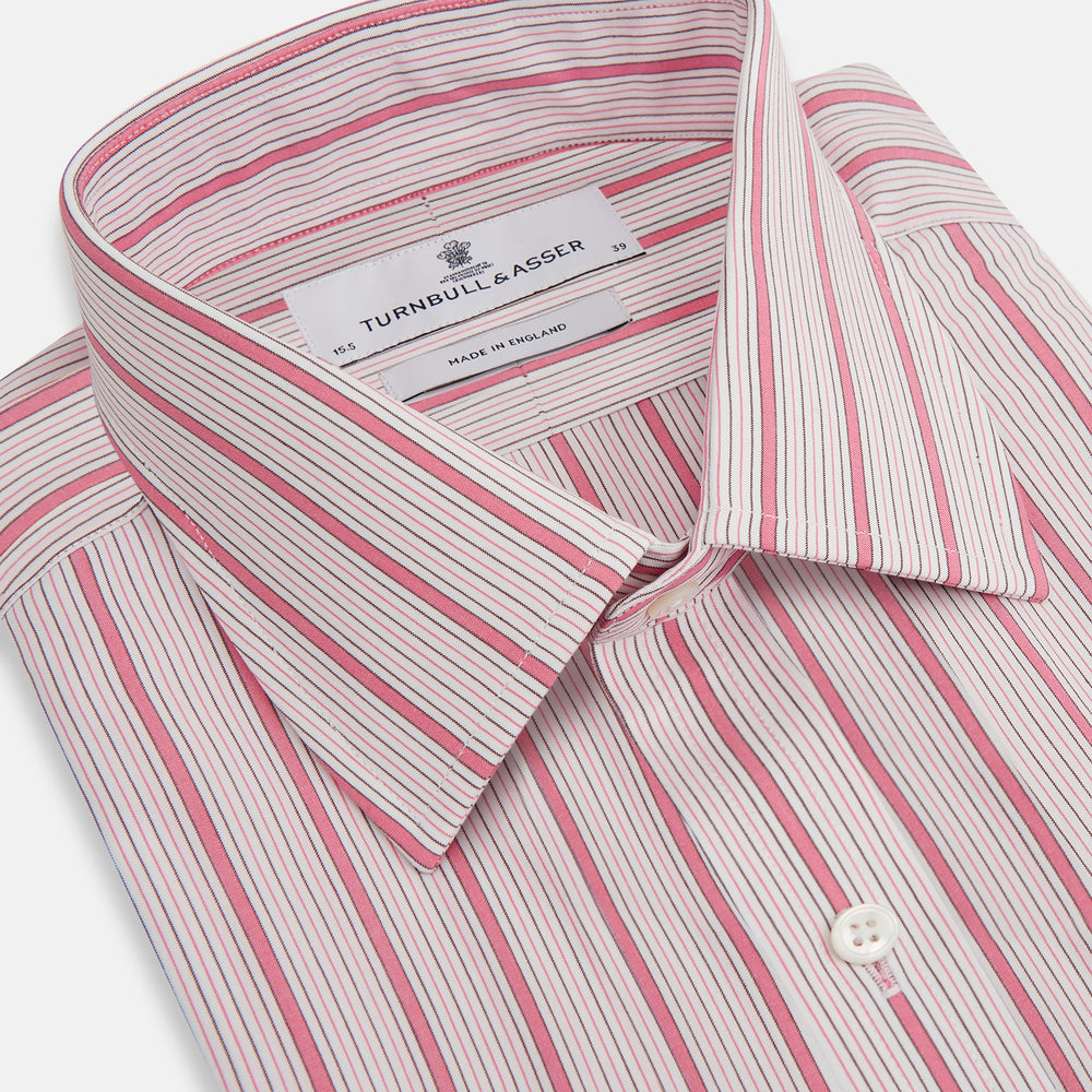 The Turnbull & Asser Pink Multi Track Stripe Mayfair Shirt features long sleeves, a button-down front, classic collar, and buttoned cuffs with red and pink stripes on white, neatly displayed on a light background.